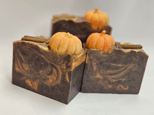 3 brown soap bars with pumpkin and cinnamon stick on top